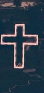 Aerial view of a neon-lit cross in the night.