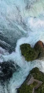 Aerial view of rushing rapids and green trees on a rocky landscape.