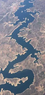 Aerial view of winding river through dry landscape.