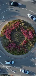 Aerial view of a floral roundabout with surrounding traffic.