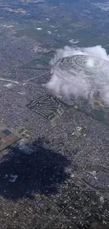 Aerial view of city with unique cloud shadow.