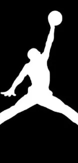 Silhouette of a basketball player jumping against a black background.