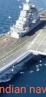 Aircraft carrier sailing on blue ocean waters.