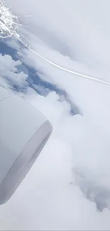 Airplane engine with clouds in the sky, captured in aerial view.