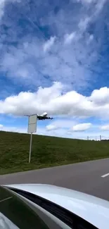 Airplane flying in a vibrant blue sky with fluffy white clouds.