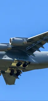 Airplane soaring through clear blue sky, perfect for mobile wallpaper.
