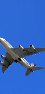 Airplane soaring in clear blue sky, perfect wallpaper for aviation enthusiasts.