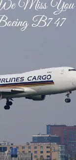 Boeing 747 in flight with skyline backdrop.