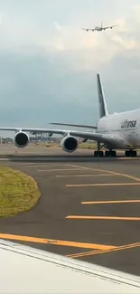 Airplane waiting on airport runway, prepared for takeoff.