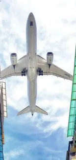 Airplane flying between urban skyscrapers, viewed from below.