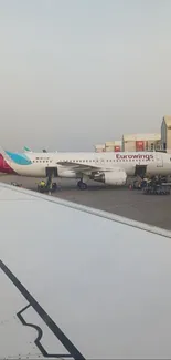 View of airplane on runway near terminal.