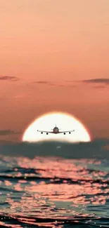 Airplane flying over a serene ocean at sunset.