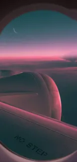 Airplane window view of a stunning pink sunset over the clouds.