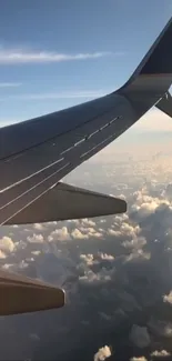 Airplane wing soaring above fluffy clouds.