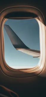 A serene view of the sky and airplane wing through a window, perfect for travel lovers.