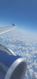 Airplane wing soaring above white fluffy clouds in a blue sky.