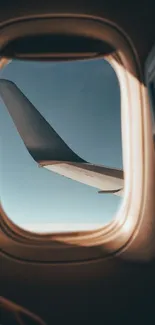 Scenic view of an airplane wing through a window on a sunny day.