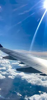 Airplane wing above clouds with blue sky