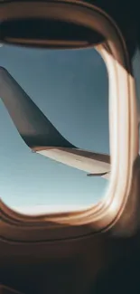 Airplane view through window with sky and wing.