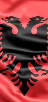 Albanian flag wallpaper with double-headed eagle on red silk texture.