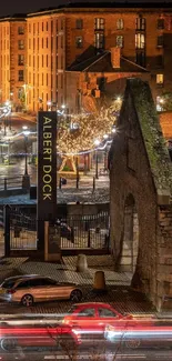 Night view of Albert Dock with illuminated buildings and lively city lights.