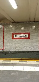 Brick wall with Alexanderplatz sign in subway station.