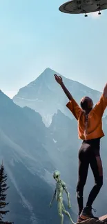 Person encountering alien and UFO in mountain landscape under blue sky.