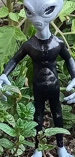 Alien figurine with greenery background