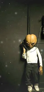 Alien in casual attire using a vintage payphone on a dark background.