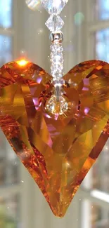 Amber crystal heart charm with sunlight reflection.