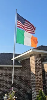 American and Irish flags on a sunny rooftop with a clear blue sky backdrop.