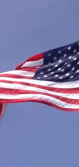 American flag waving against a blue sky background mobile wallpaper.