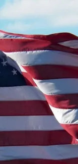 American flag waving on a clear day sky background.