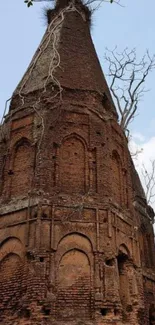 Ancient brick tower with sky background for mobile wallpaper.