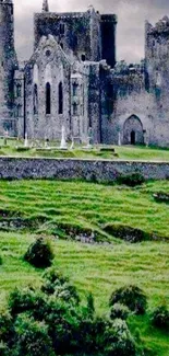 Medieval castle with lush green landscape, ancient stone architecture, cloudy sky.