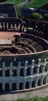 Aerial view of the ancient Colosseum in Rome with lush greenery surrounding.