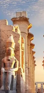 Beautiful ancient Egyptian temple with statues under a vibrant sky.