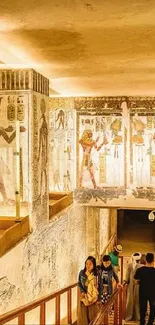 Illuminated Egyptian tomb passage with hieroglyphs and ancient art.