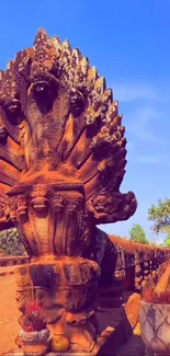 Ancient stone sculpture under clear blue sky.