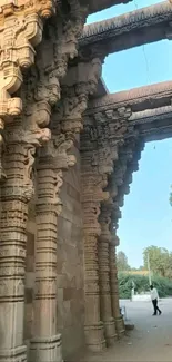 Ancient stone archway with detailed carvings in natural surroundings.