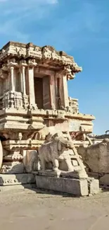 Ancient stone chariot in Hampi under a blue sky.