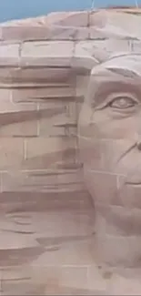 Ancient stone face sculpture on wall.