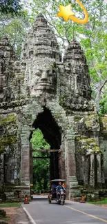 Angkor Wat stone gateway with lush greenery and a clear sky.