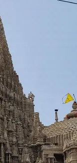 Ancient temple under a clear blue sky with intricate carvings.