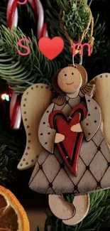 Wooden angel with heart on Christmas tree.