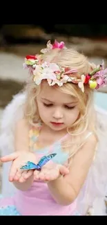 Child with angel wings and a blue butterfly in hands.