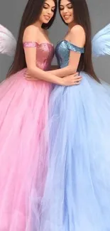 Angelic duo with pink and blue gowns and wings.