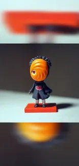 Anime character figurine on red base in vibrant wallpaper.