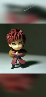 Chibi anime character with red hair and green eyes in a dark background.