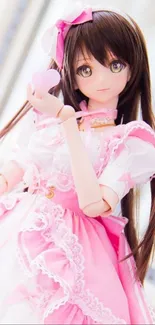 Anime doll wearing a pink dress with a heart accessory.